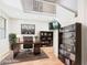 Stylish home office with wood floors, a comfortable desk setup, and elegant built-in shelving at 20615 W Daniel Pl, Buckeye, AZ 85396