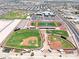 Aerial view of community sports fields, baseball field, tennis court, and track at 20615 W Daniel Pl, Buckeye, AZ 85396