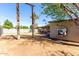 Spacious backyard with a covered patio, dirt area, and block wall fence, offering privacy and potential at 2064 W 2Nd St, Mesa, AZ 85201