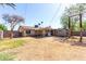 Backyard with a covered patio, dirt area, and surrounding block wall, providing a spacious outdoor area at 2064 W 2Nd St, Mesa, AZ 85201