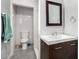Modern bathroom features gray floors, a white countertop sink, dark brown cabinet, and brushed silver hardware at 2064 W 2Nd St, Mesa, AZ 85201