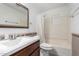 Bathroom featuring an undermount sink, framed mirror, decorative trim and a shower/bath combo at 2064 W 2Nd St, Mesa, AZ 85201