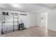 An organized bedroom featuring a clothing rack, plastic storage bins, and an air conditioning unit at 2064 W 2Nd St, Mesa, AZ 85201