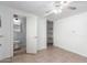 Bedroom featuring an open doorway to a bathroom, ceiling fan and tile floor at 2064 W 2Nd St, Mesa, AZ 85201