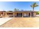 Inviting single-story home with a desert landscape, solar panels, and a mature palm tree at 2064 W 2Nd St, Mesa, AZ 85201