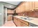 Well-equipped kitchen with wood cabinets, stainless steel appliances, and tiled backsplash for cooking at 2064 W 2Nd St, Mesa, AZ 85201
