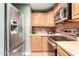 Kitchen features stainless steel appliances, tile backsplash, and light-colored wood cabinetry at 2064 W 2Nd St, Mesa, AZ 85201