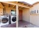 This indoor/outdoor laundry area features full size washing machines, and an enclosed outdoor patio at 2064 W 2Nd St, Mesa, AZ 85201