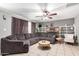 Spacious living room featuring a ceiling fan, tile floors, and a cozy sectional sofa at 2064 W 2Nd St, Mesa, AZ 85201