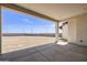 View of the large backyard from covered patio, ideal for outdoor activities or future landscaping projects at 2087 N 77Th Pl, Mesa, AZ 85207