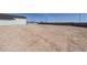 Spacious backyard with dirt landscaping and a block fence, offering a blank canvas for customization at 2087 N 77Th Pl, Mesa, AZ 85207