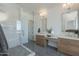 Spa-like bathroom showcasing dual vanities, a glass-enclosed shower, and modern fixtures at 2087 N 77Th Pl, Mesa, AZ 85207