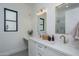 Bright bathroom features double vanity with quartz countertop, gold fixtures and a modern, minimalist design at 2087 N 77Th Pl, Mesa, AZ 85207