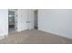 Bright bedroom with neutral carpet and white trim, featuring closet doors and ample natural light at 2087 N 77Th Pl, Mesa, AZ 85207