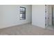 Bright bedroom with neutral carpet, clean white walls, and a window allowing natural light at 2087 N 77Th Pl, Mesa, AZ 85207