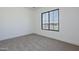 Neutral carpeted bedroom featuring a window that offers natural light and outdoor views at 2087 N 77Th Pl, Mesa, AZ 85207