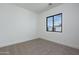 Carpeted bedroom with a neutral palette, a large window, and natural light for a relaxing feel at 2087 N 77Th Pl, Mesa, AZ 85207