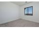 Cozy bedroom with neutral carpeting, featuring a window that brings in natural light at 2087 N 77Th Pl, Mesa, AZ 85207