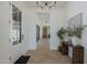 Welcoming foyer with high ceilings, herringbone floors, and an elegant chandelier, setting a sophisticated tone at 2087 N 77Th Pl, Mesa, AZ 85207