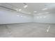 Bright, empty garage shows many lights, painted white walls and floor; ready for immediate use and storage at 2087 N 77Th Pl, Mesa, AZ 85207