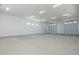 Expansive garage features two overhead doors with bright lights, offering ample space for vehicles and storage at 2087 N 77Th Pl, Mesa, AZ 85207