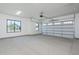 Spacious garage with large window and overhead door offering ample storage for vehicles and other items at 2087 N 77Th Pl, Mesa, AZ 85207