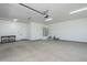 Well-lit garage provides lots of functional open space with a minimalist style and access to utilities and storage at 2087 N 77Th Pl, Mesa, AZ 85207