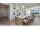 Gourmet kitchen features a large island with seating, pendant lighting, and modern appliances for a seamless cooking experience at 2087 N 77Th Pl, Mesa, AZ 85207