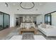 Spacious living room with high ceilings and modern decor, including an elegant chandelier and neutral-toned furniture at 2087 N 77Th Pl, Mesa, AZ 85207