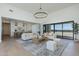 Bright open living room with a modern chandelier and large sliding glass doors showcasing the outdoor view at 2087 N 77Th Pl, Mesa, AZ 85207