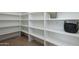 Walk-in pantry with organized shelving providing ample storage space for all your kitchen essentials and supplies at 2087 N 77Th Pl, Mesa, AZ 85207