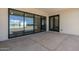 Covered patio features concrete flooring, sliding glass doors, and an additional doorway leading inside at 2087 N 77Th Pl, Mesa, AZ 85207