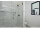 Modern tiled shower with glass door and gold hardware, offering a clean and stylish design at 2087 N 77Th Pl, Mesa, AZ 85207