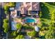 The backyard features a pristine pool area surrounded by lush greenery and patio space for outdoor living at 2107 E Park Ave, Gilbert, AZ 85234
