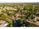 Lush aerial view captures a home, pool, and neighborhood amenities amidst mature trees at 2107 E Park Ave, Gilbert, AZ 85234