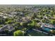 Beautiful aerial view of a home with pool, tennis court and mature landscaping in a leafy neighborhood at 2107 E Park Ave, Gilbert, AZ 85234