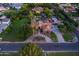 An aerial view reveals an immaculate residence surrounded by mature trees and lush landscaping at 2107 E Park Ave, Gilbert, AZ 85234