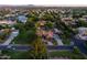 Aerial view of residential street showing lush landscaping, palm trees and mature foliage at 2107 E Park Ave, Gilbert, AZ 85234