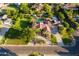 Stunning aerial view of a home with a refreshing pool, lush landscaping, and a circular driveway at 2107 E Park Ave, Gilbert, AZ 85234