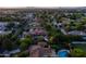 Expansive aerial view showcasing the property's swimming pool, lush landscaping, and surrounding neighborhood at 2107 E Park Ave, Gilbert, AZ 85234