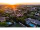Expansive aerial view of a residential community at sunrise showcasing lush landscaping and beautiful single-Gathering homes at 2107 E Park Ave, Gilbert, AZ 85234