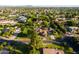 Expansive aerial view showcasing a home in a lush neighborhood with mountain views at 2107 E Park Ave, Gilbert, AZ 85234