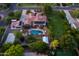 Aerial view of a luxury home with a pool, solar panels, putting green, and lush landscaping at 2107 E Park Ave, Gilbert, AZ 85234