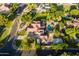 Aerial view of an estate showcasing mature trees, a pool, solar panels and surrounding greenery at 2107 E Park Ave, Gilbert, AZ 85234