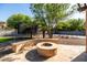 A backyard firepit area, trampoline, and privacy landscaping provide ample room to enjoy outdoor living at 2107 E Park Ave, Gilbert, AZ 85234