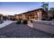 Covered patio with lights and dining, outdoor kitchen and fireplace, and a view of the pool at 2107 E Park Ave, Gilbert, AZ 85234