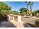 Outdoor kitchen with stainless grill, hammock, and palm trees add to this outdoor living space at 2107 E Park Ave, Gilbert, AZ 85234