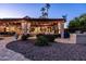 Entertainer's backyard featuring a covered patio with lighting, fireplace and views of the pool area at 2107 E Park Ave, Gilbert, AZ 85234