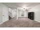 Spacious basement with carpet flooring and access to a hallway and staircase at 2107 E Park Ave, Gilbert, AZ 85234