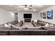 Spacious basement featuring a large sectional couch, flat screen TV, and comfortable carpet flooring at 2107 E Park Ave, Gilbert, AZ 85234